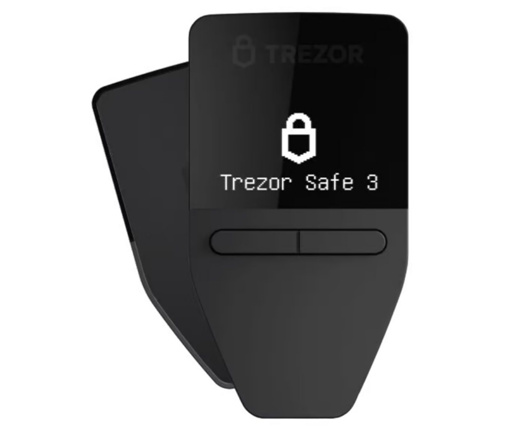 Trezor Safe 3 hardware wallet in matte black, showing its display screen with a padlock icon and the text "Trezor Safe 3." Used for secure offline storage of cryptocurrency private keys.