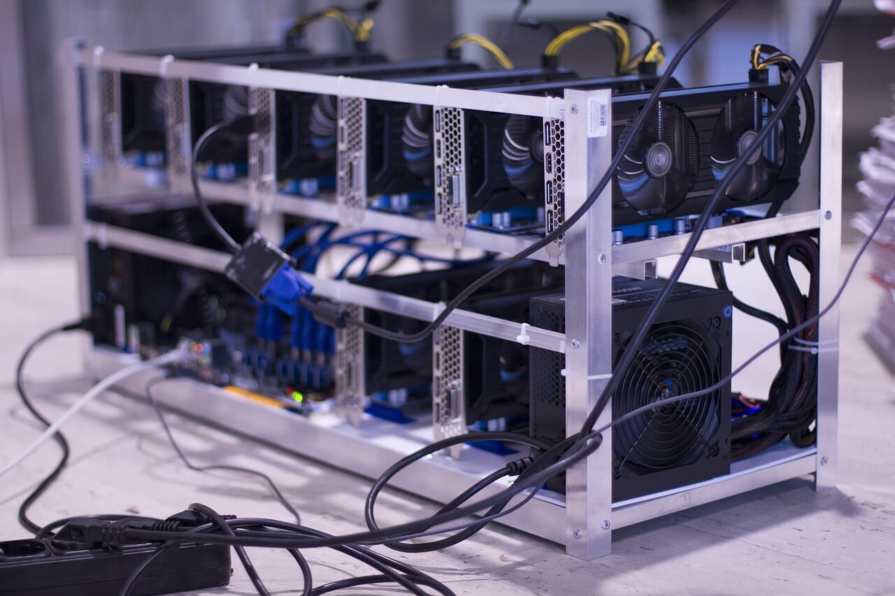 An image depicting a crypto mining farm with powerful computers.